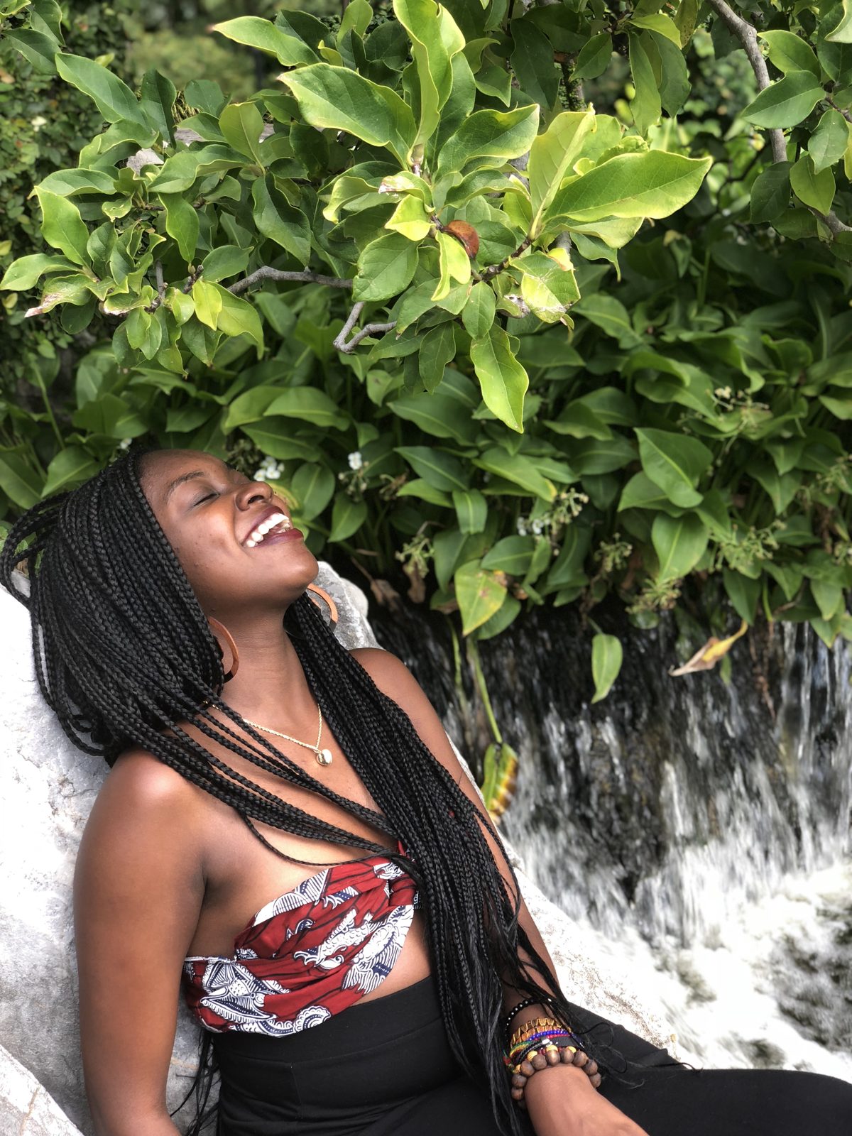 The founder of For Lilia laughing beside a waterfall